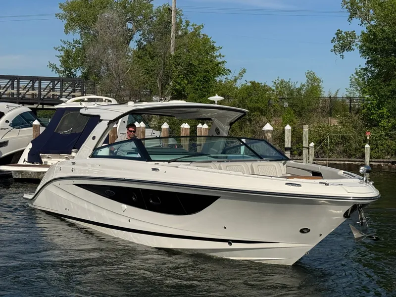 Slide: The Image of 2023 Sea Ray SLX 400 boat on calm water. - 2
