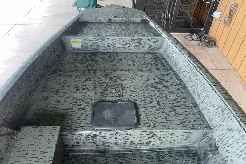 Slide: The Image of Interior view of a 2026 War Eagle 750 Gladiator boat with camouflage pattern. - 17