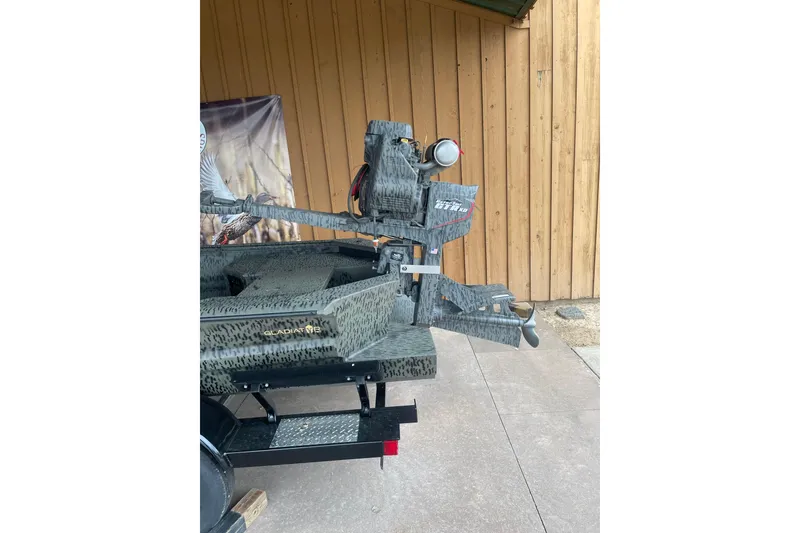 Slide: The Image of 2026 War Eagle 750 Gladiator boat with camouflage design, displayed outdoors. - 6