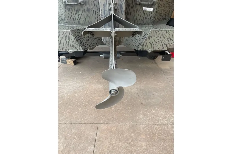 Slide: The Image of Propeller of 2026 War Eagle 750 Gladiator boat on concrete surface. - 8