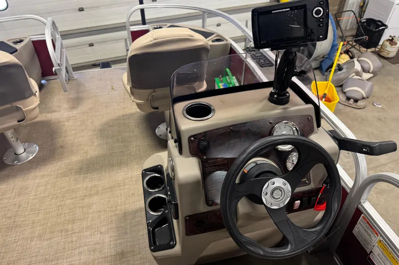 Slide: The Image of 2022 Sun Tracker Bass Buggy 18 DLX boat interior with steering console and fish finder. - 10