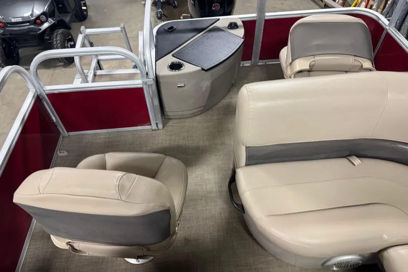 Slide: The Image of 2022 Sun Tracker Bass Buggy 18 DLX interior with beige seating and red paneling. - 12