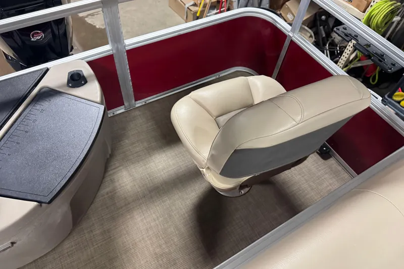 Slide: The Image of 2022 Sun Tracker Bass Buggy 18 DLX boat interior with beige seating and red paneling. - 13