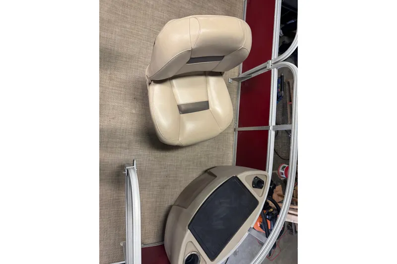 Slide: The Image of 2022 Sun Tracker Bass Buggy 18 DLX interior with beige seating and control panel. - 5