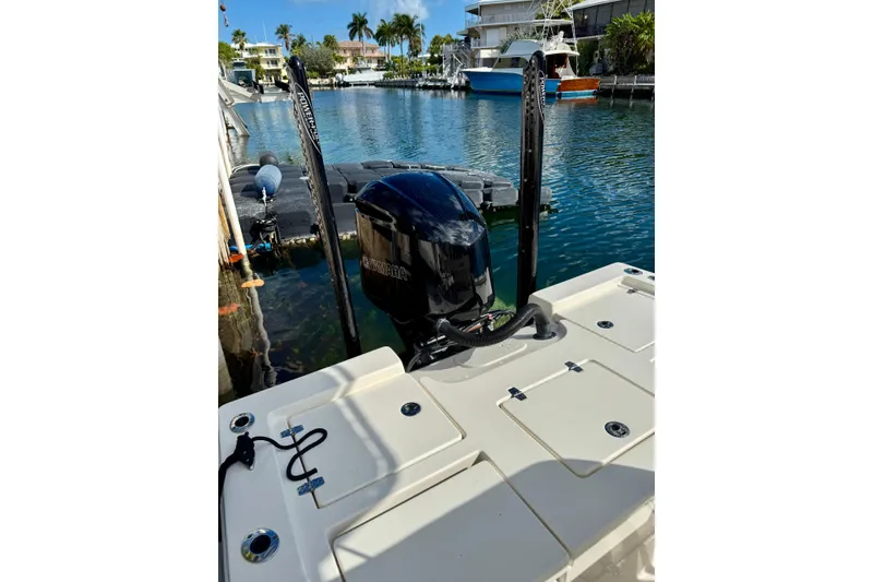 Slide: The Image of 2021 Pathfinder 2400 TRS boat with Yamaha engine docked in a scenic marina. - 11