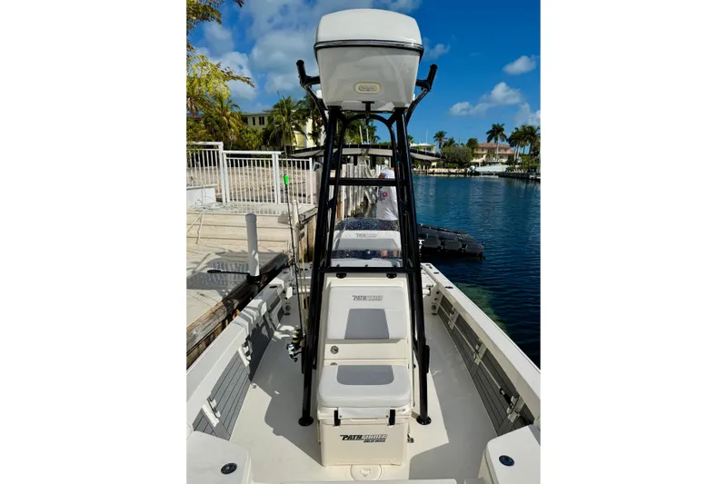 Slide: The Image of 2021 Pathfinder 2400 TRS boat docked by a scenic waterfront under a clear blue sky. - 3