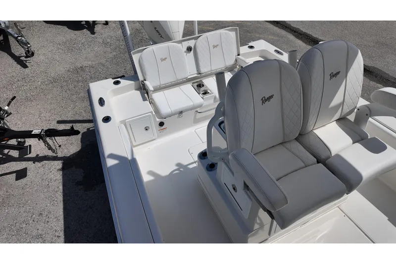 Slide: The Image of 2024 Ranger 2660 Bay boat interior with cushioned seating and storage compartments. - 12