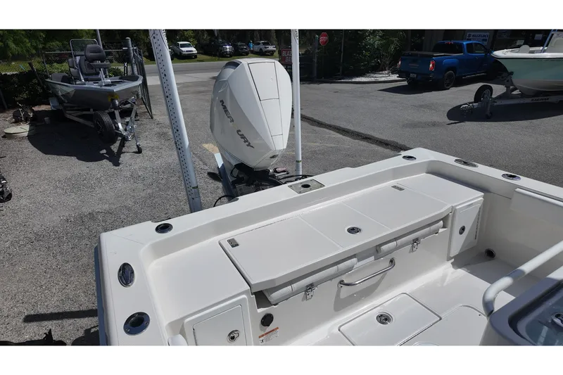Slide: The Image of 2024 Ranger 2660 Bay boat with Mercury engine, parked outdoors. - 14