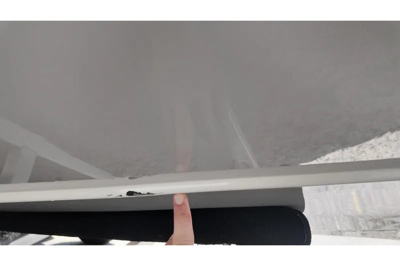 Slide: The Image of Close-up of 2024 Ranger 2660 Bay boat hull with minor damage. - 22