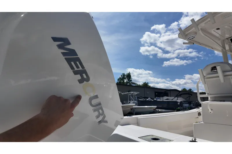 Slide: The Image of 2024 Ranger 2660 Bay boat with Mercury engine under a clear blue sky. - 23