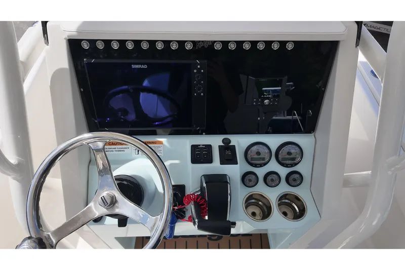 Slide: The Image of 2024 Ranger 2660 Bay boat dashboard with steering wheel, gauges, and navigation system. - 7