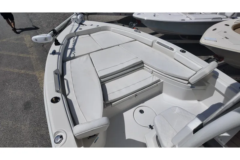 Slide: The Image of 2024 Ranger 2660 Bay boat interior with white seating and modern design. - 8