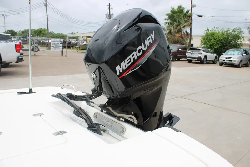 Slide: The Image of 2021 Mako Pro Skiff 17 CC with Mercury outboard motor in a parking lot. - 12
