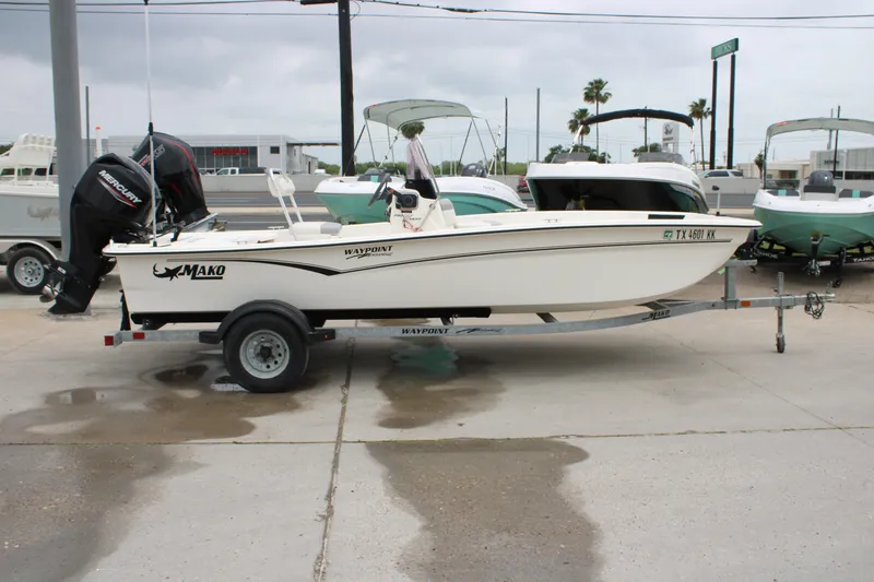 Slide: The Image of 2021 Mako Pro Skiff 17 CC boat on trailer, parked outdoors. - 2