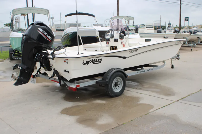 Slide: The Image of 2021 Mako Pro Skiff 17 CC boat on trailer with Mercury outboard motor. - 3