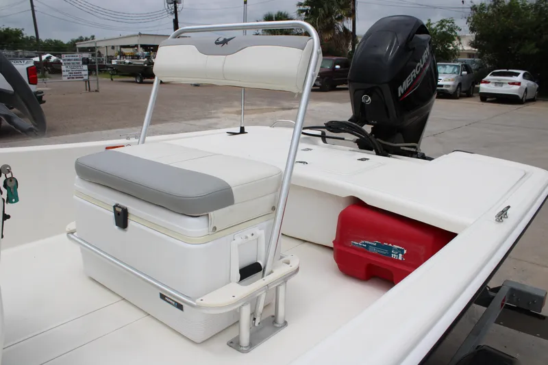 Slide: The Image of 2021 Mako Pro Skiff 17 CC boat interior with seating and Mercury outboard motor. - 6