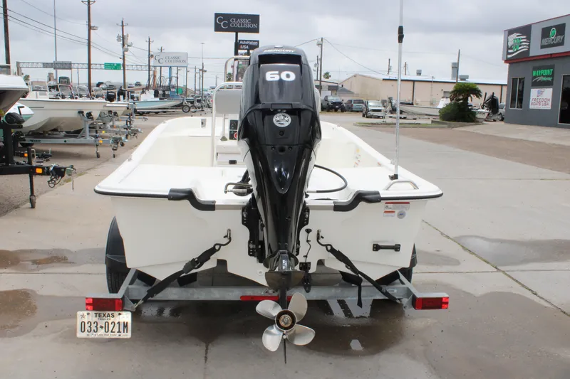 Slide: The Image of 2021 Mako Pro Skiff 17 CC boat with outboard motor on a trailer. - 8