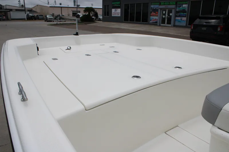 Slide: The Image of 2021 Mako Pro Skiff 17 CC boat deck, spacious and clean, in a dealership lot. - 9
