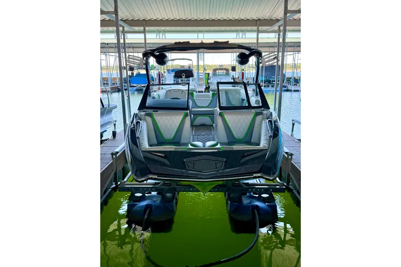 Slide: The Image of 2016 Tigé RZX3 boat docked, featuring sleek design and modern seating. - 15