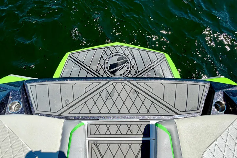 Slide: The Image of 2016 Tigé RZX3 boat deck with stylish gray and green design on sparkling water. - 20