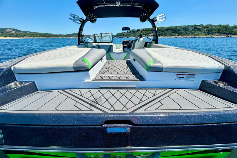 Slide: The Image of 2016 Tigé RZX3 boat on water, featuring spacious seating and sleek design. - 21