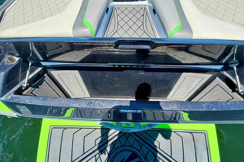 Slide: The Image of 2016 Tigé RZX3 boat interior with open storage compartment, featuring sleek design and vibrant accents. - 22