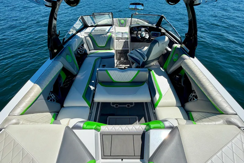Slide: The Image of 2016 Tigé RZX3 boat interior with luxurious seating and modern design on open water. - 25
