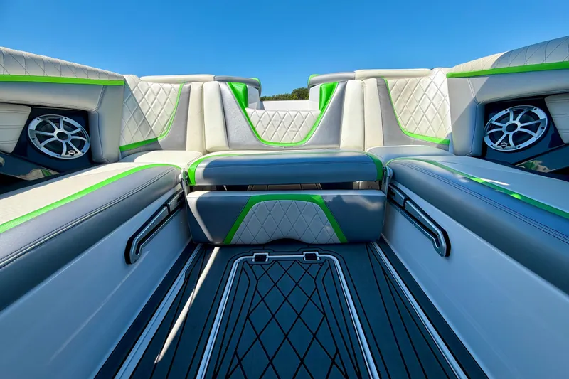 Slide: The Image of 2016 Tigé RZX3 boat interior with stylish seating and vibrant green accents. - 27