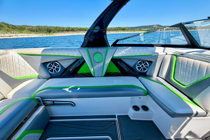 Slide: The Image of Interior of 2016 Tigé RZX3 boat with stylish seating and vibrant green accents. - 28