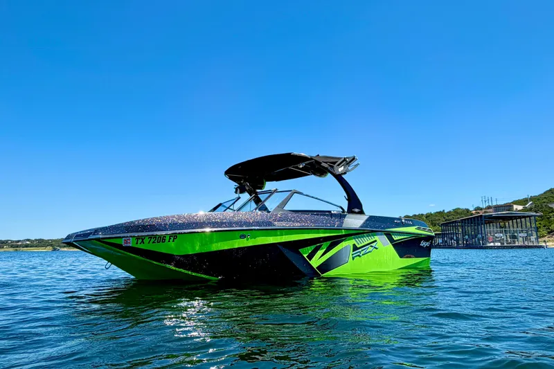 Slide: The Image of 2016 Tigé RZX3 boat in vibrant green on a sunny lake. - 3