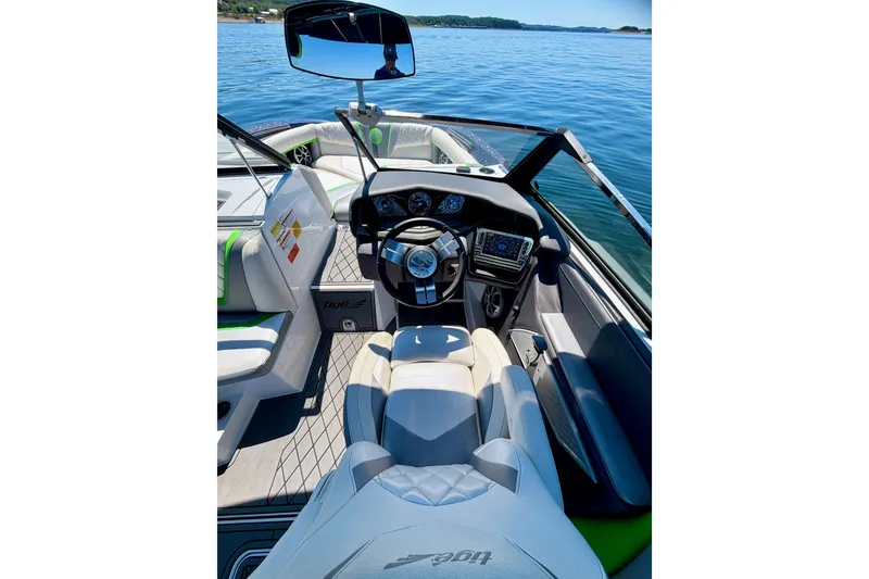 Slide: The Image of Interior view of 2016 Tigé RZX3 boat, featuring sleek dashboard and comfortable seating. - 32