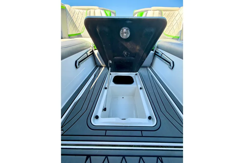 Slide: The Image of 2016 Tigé RZX3 boat storage compartment open, showcasing interior space and sleek design. - 37