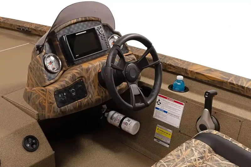 Slide: The Image of Manufacturer Provided Image: 2026 G3 Sportsman 1710 boat dashboard with steering wheel and control panel. - 2