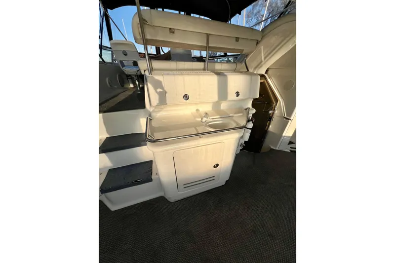 Slide: The Image of 1997 Sea Ray 370 Aft Cabin interior with sink and seating area. - 13