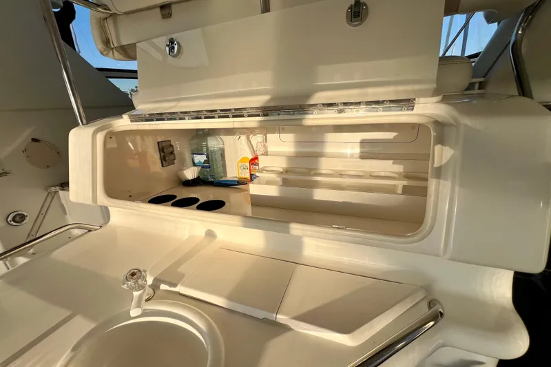 Slide: The Image of 1997 Sea Ray 370 Aft Cabin yacht interior with kitchenette and storage compartments. - 14