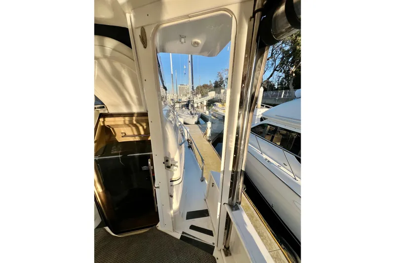 Slide: The Image of 1997 Sea Ray 370 Aft Cabin yacht interior view with marina background. - 18