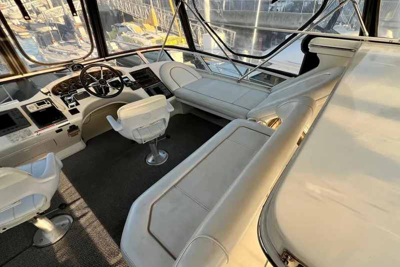 Slide: The Image of 1997 Sea Ray 370 Aft Cabin yacht interior with helm, seating, and navigation equipment. - 21