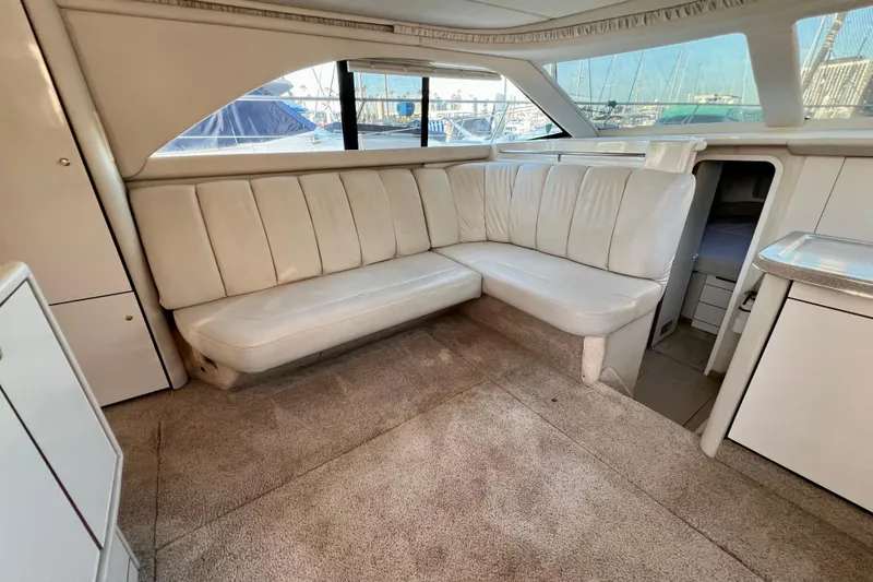 Slide: The Image of 1997 Sea Ray 370 Aft Cabin interior with white leather seating and carpeted floor. - 28