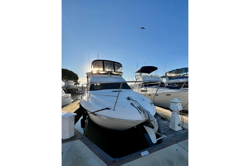 Slide: The Image of 1997 Sea Ray 370 Aft Cabin yacht docked at marina under clear blue sky. - 3