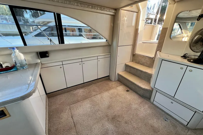 Slide: The Image of Interior of 1997 Sea Ray 370 Aft Cabin yacht with carpeted floor and cabinetry. - 30