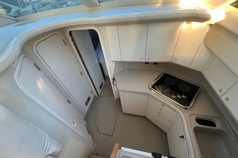Slide: The Image of 1997 Sea Ray 370 Aft Cabin interior kitchen with stove and cabinets. - 35
