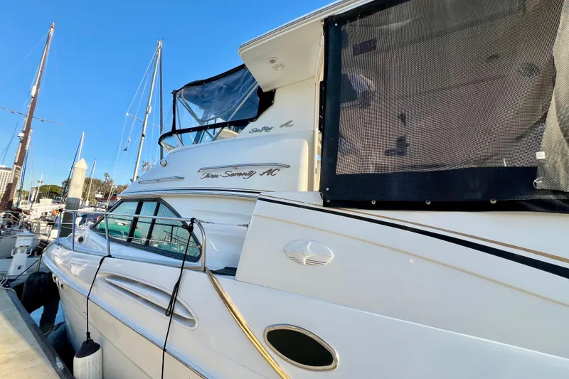 Slide: The Image of 1997 Sea Ray 370 Aft Cabin yacht docked at marina under clear blue sky. - 4