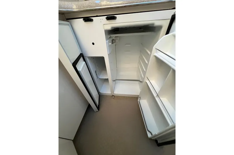 Slide: The Image of 1997 Sea Ray 370 Aft Cabin boat interior with open refrigerator in kitchen area. - 45