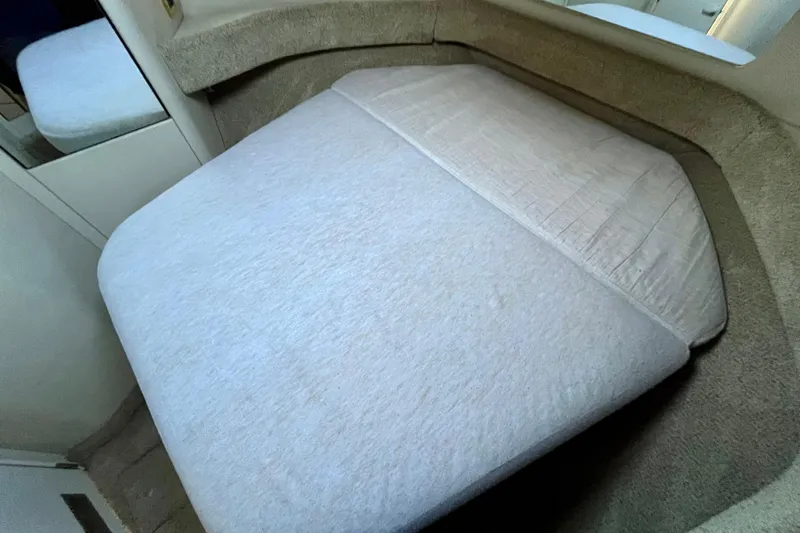 Slide: The Image of 1997 Sea Ray 370 Aft Cabin interior with a neatly made bed. - 49