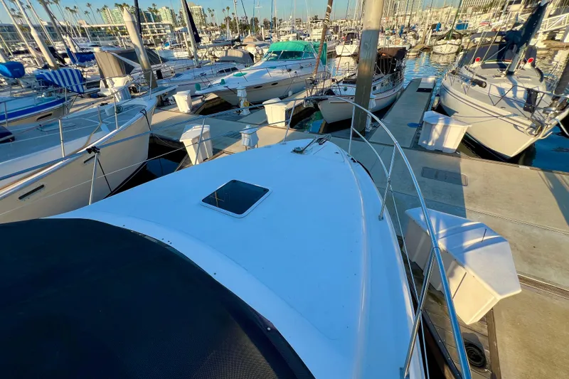 Slide: The Image of 1997 Sea Ray 370 Aft Cabin yacht docked in a marina, surrounded by other boats. - 5