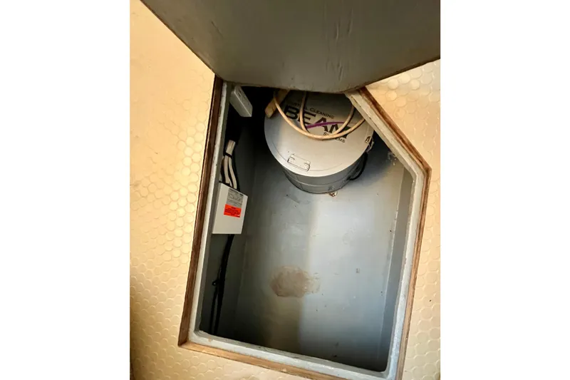 Slide: The Image of 1997 Sea Ray 370 Aft Cabin storage compartment with cleaning equipment and wiring. - 52
