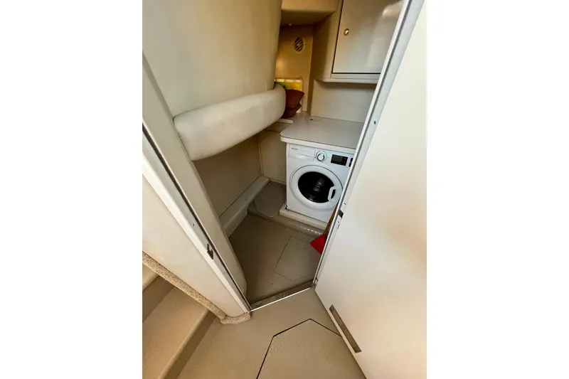 Slide: The Image of 1997 Sea Ray 370 Aft Cabin interior with washing machine and storage space. - 56