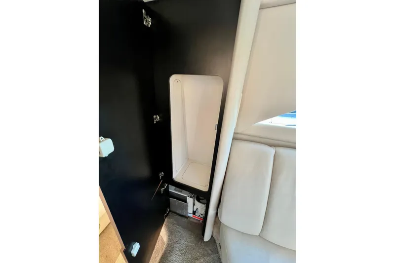 Slide: The Image of 1997 Sea Ray 370 Aft Cabin interior with storage compartment and seating. - 59