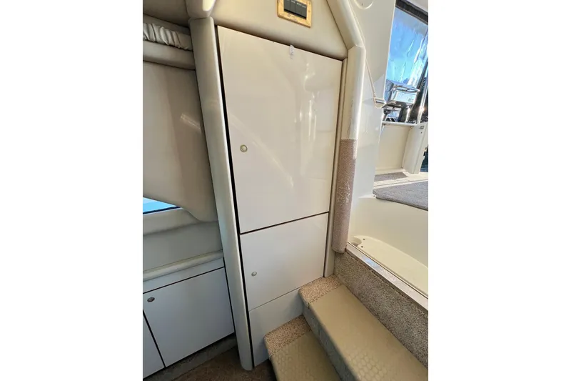 Slide: The Image of 1997 Sea Ray 370 Aft Cabin interior with stairs and storage cabinets. - 60