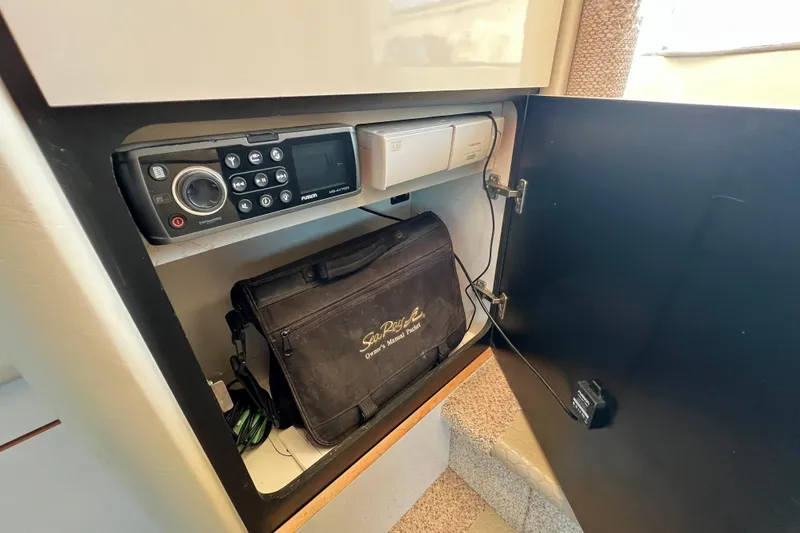 Slide: The Image of 1997 Sea Ray 370 Aft Cabin storage with radio and owner's manual bag. - 62